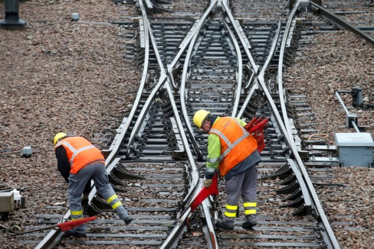 FILE PHOTO: French state-owned railway company SNCF workers inspect the tracks at a SNCF depot station in Charenton-le-Pont near Paris